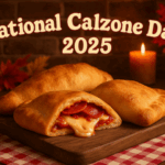 Golden-brown calzones on a rustic wooden board, one sliced open with melted cheese and pepperoni beside autumn leaves and candlelight.